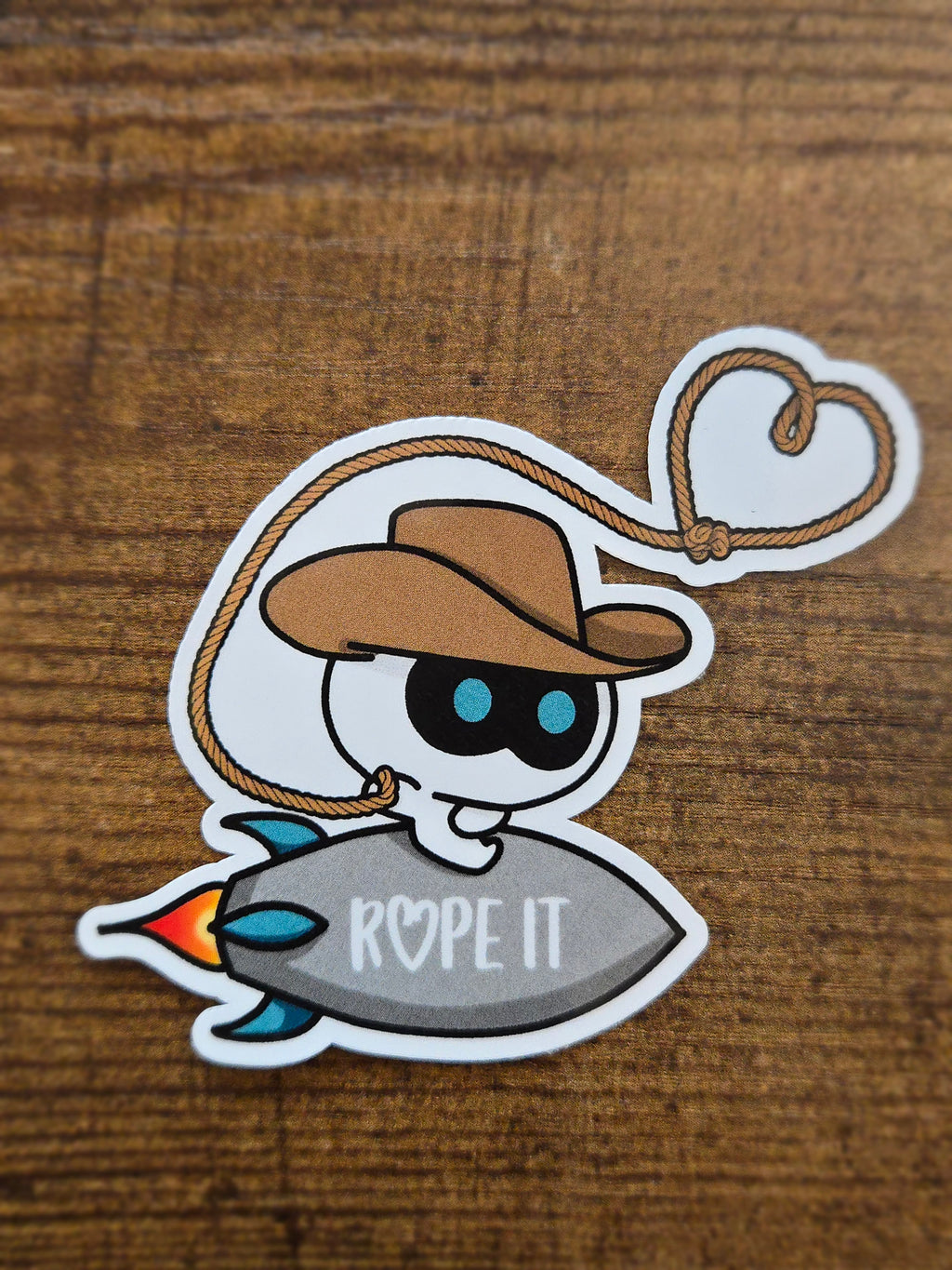 Rope IT!! BTS Jin-inspired sticker featuring Cowboy Wootteo lassoing up some love.